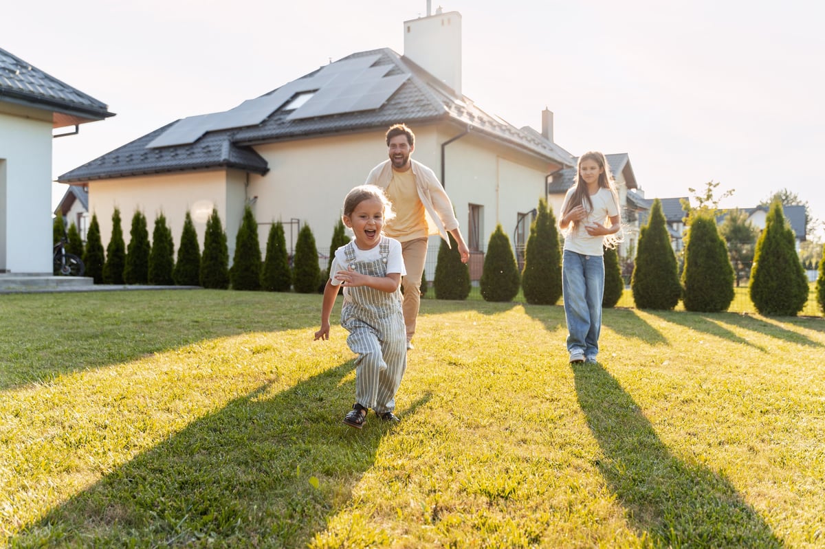 A father and his children playing on the lawn near their home in McKinney, TX