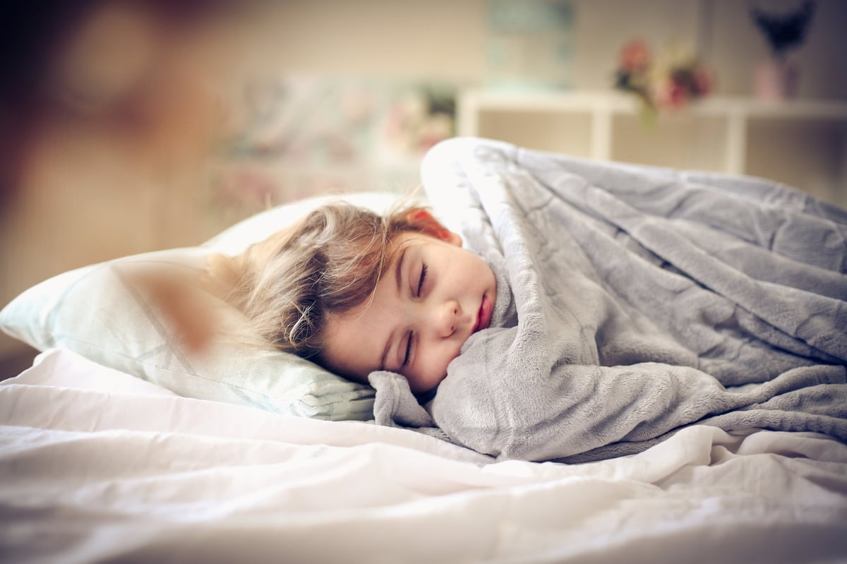 Little girl sleeping in bed.